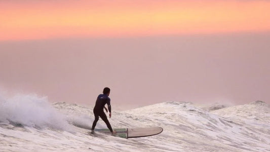 A person surfing during sunset