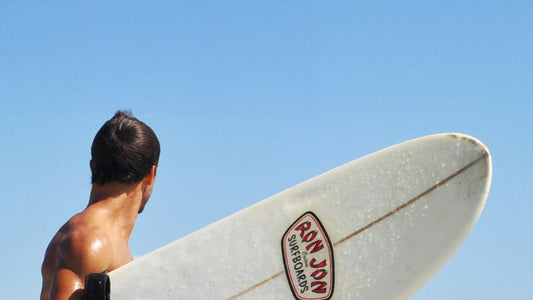 A surfer holding a surfboard