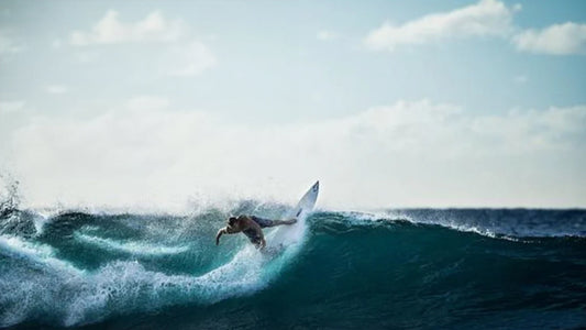Man in wetsuit surfing a wave