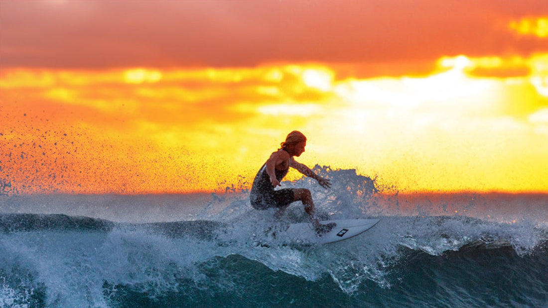 Surfer in wetsuit balancing on a surfboard riding a wave