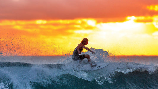 Surfer in wetsuit balancing on a surfboard riding a wave