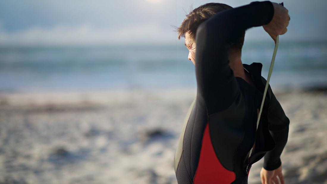 Man unzipping his wetsuit