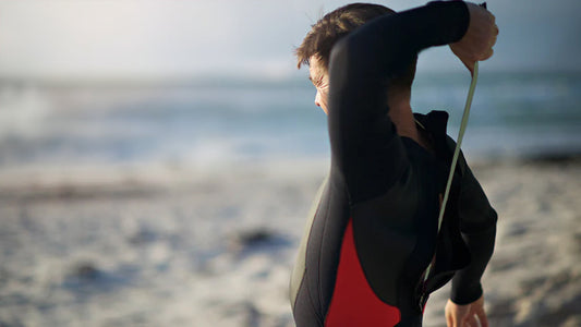 Two men walking on the beach after surfing
