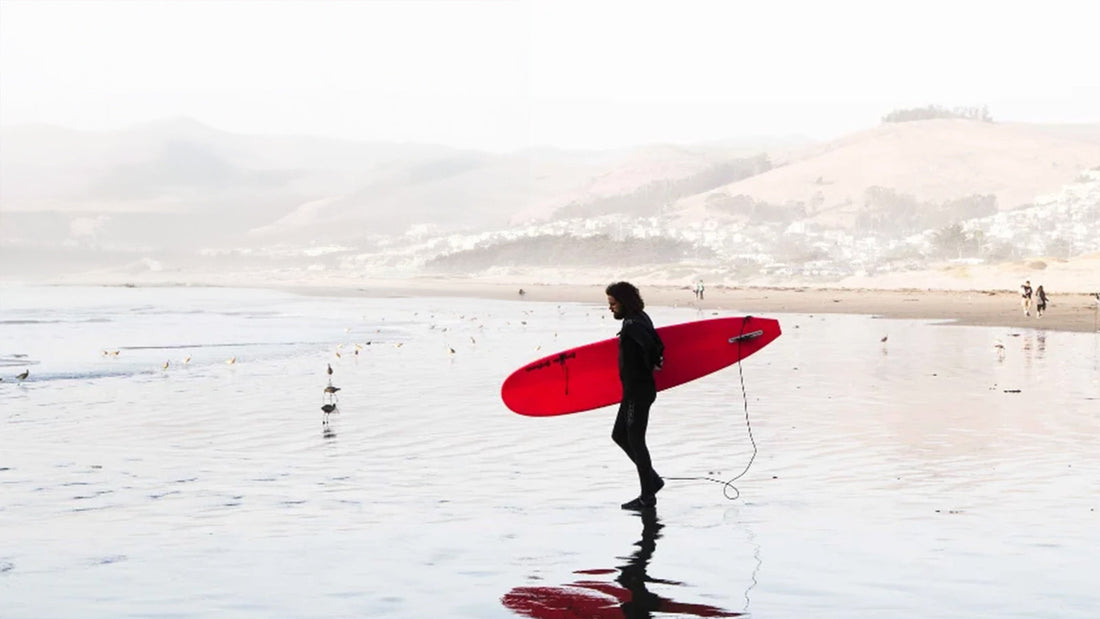 man walking into the waves 