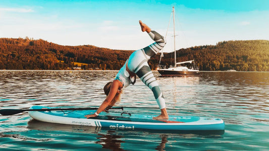 Women doing yoga on a SUP board