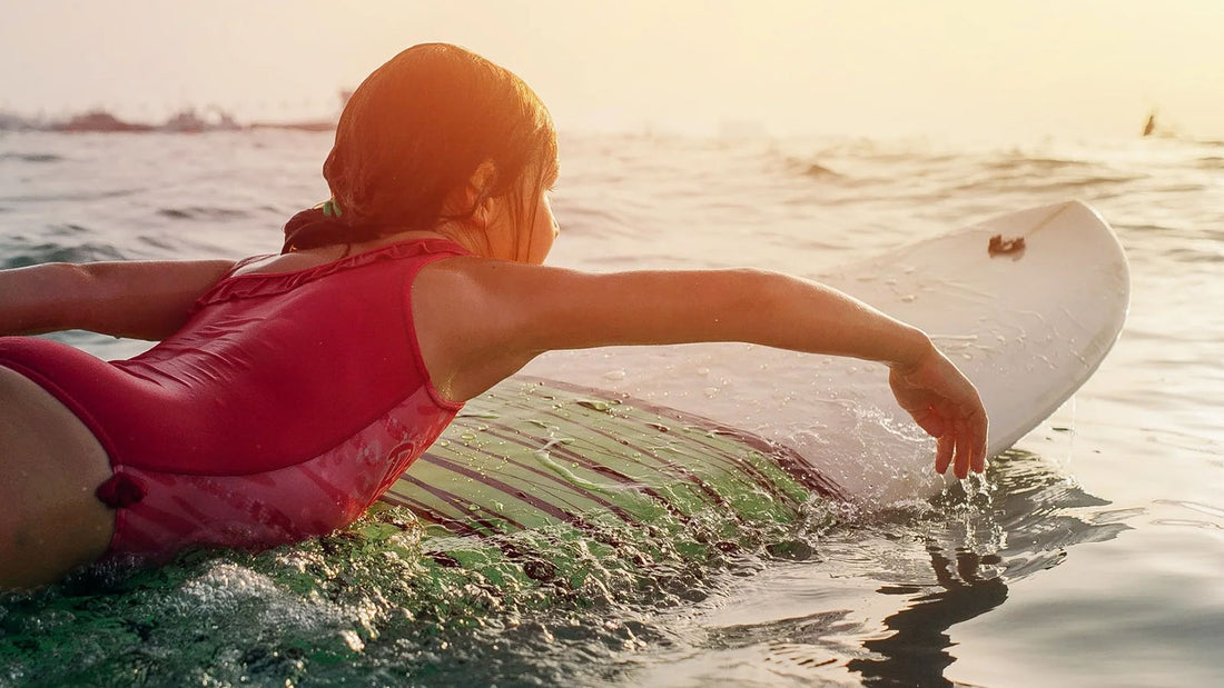 child paddling a surfboard