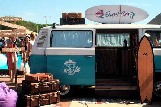 A campervan and some suitcases at a surf camp