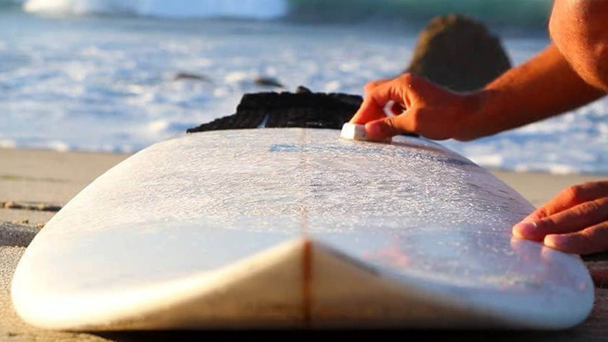 waxing a surfboard