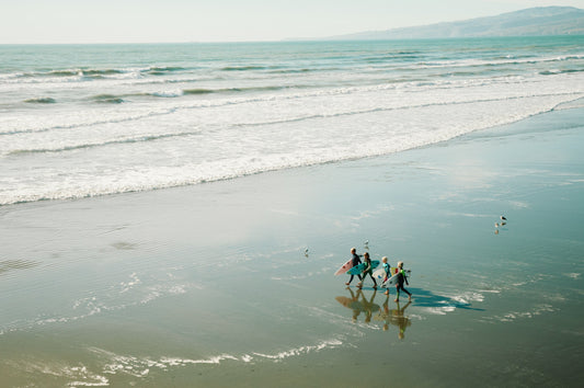 Surfers walking on a beack