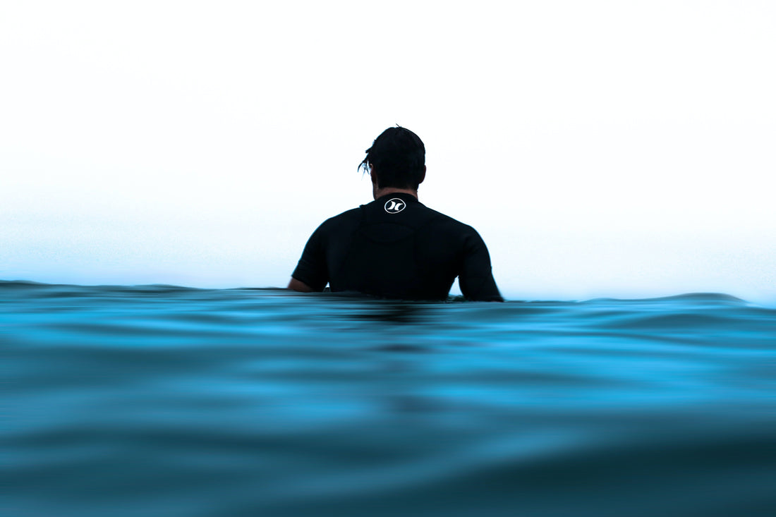 A man wearing a wetsuit in water