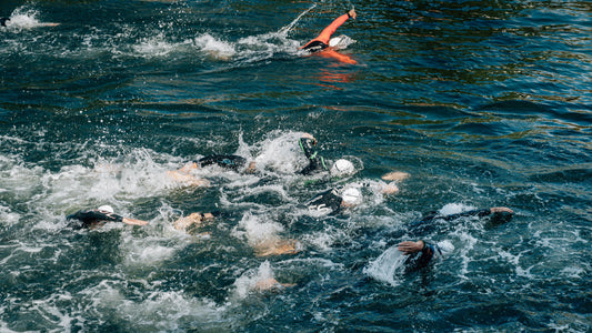 A group of swimmers swimming in a triathlon