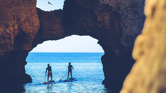 Two people SUP boarding on the sea