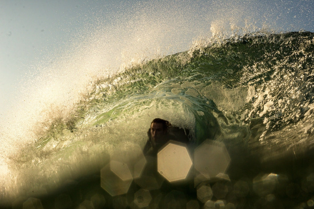 A man bodyboarding a barrel wave