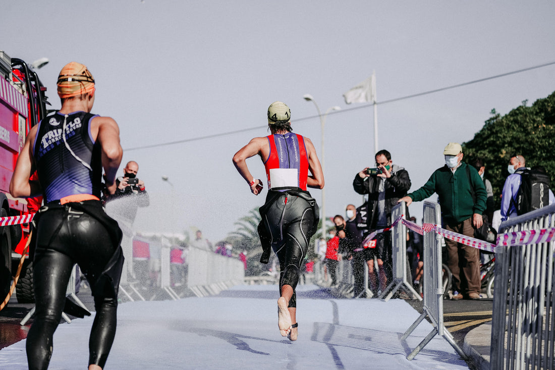 A woman and a man running in a triathlon
