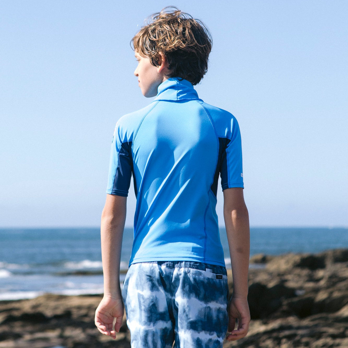 C-Skins NuWave Rash X Junior Short Sleeve Rash Vest - Cyan/Slate/Multi