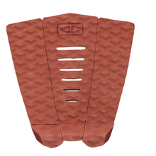 Red surfboard tail pad with geometric pattern on a white background