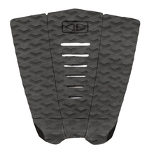 Washed black surfboard tail pad with geometric pattern on a white background.