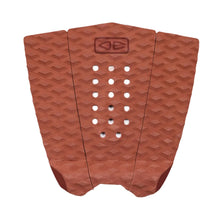 Brick coloured surfboard fish tail pad with geometric pattern on a white background
