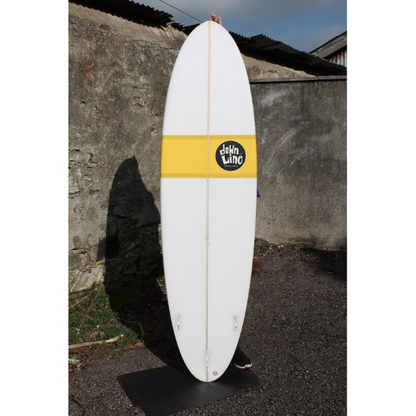 Fun surfboard in white with a yellow strip and black and white logo on a lifestyle shot background