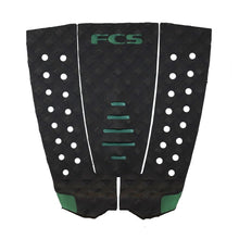 Black and green traction tail pad with geometric patterns on a white background